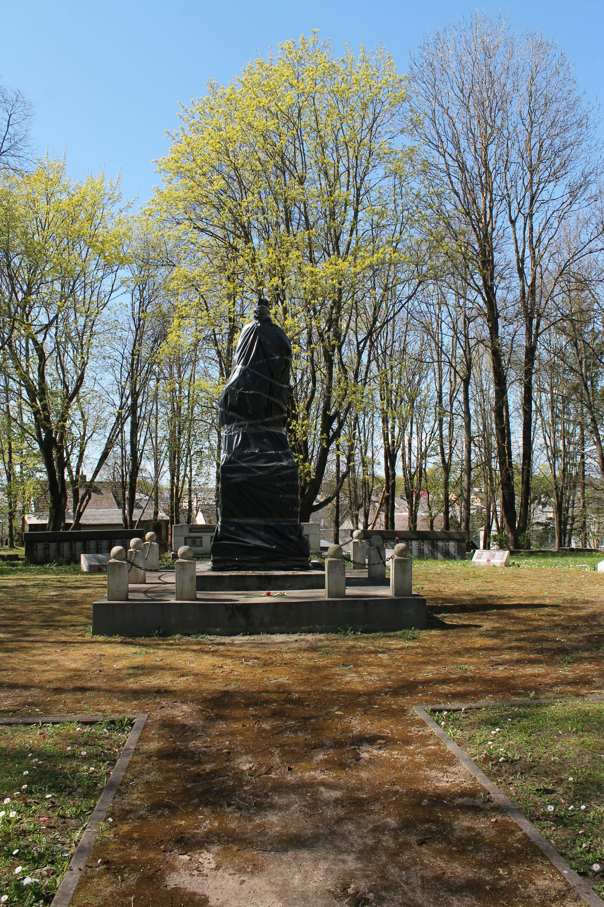 A Soviet-era monument covered in black garbage bags