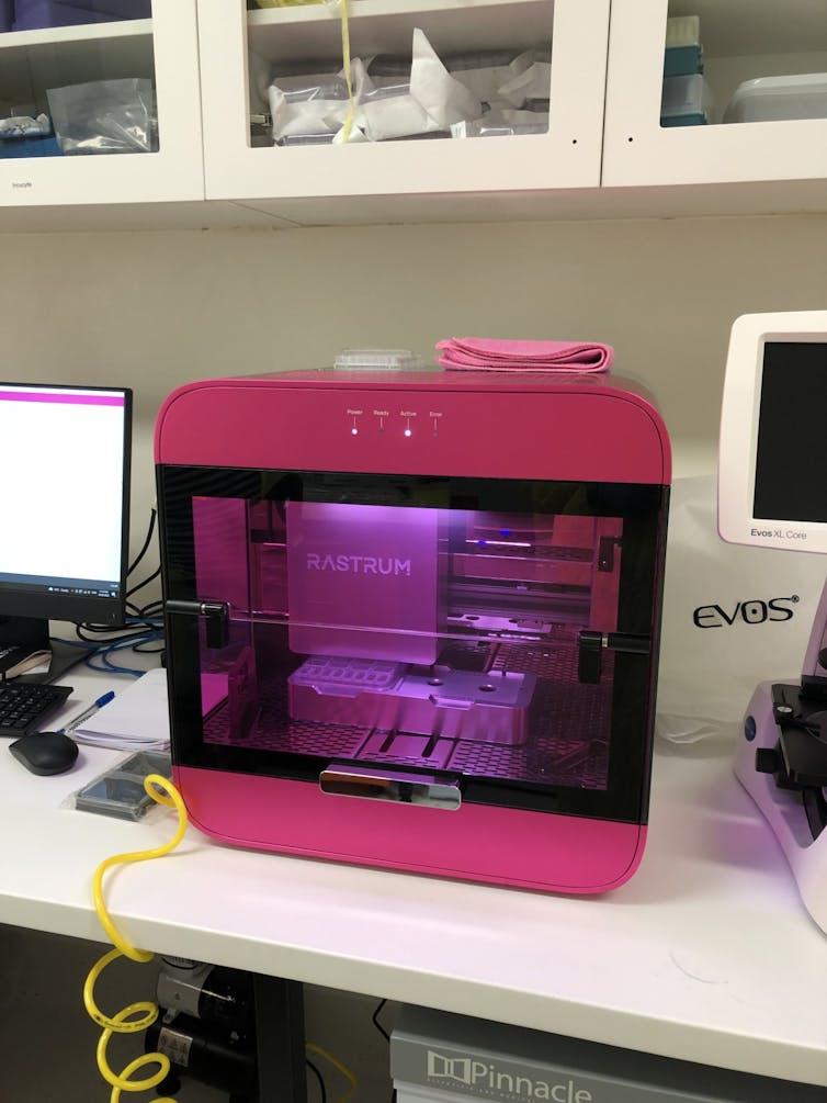 A device with a clear cabinet sitting on a bench