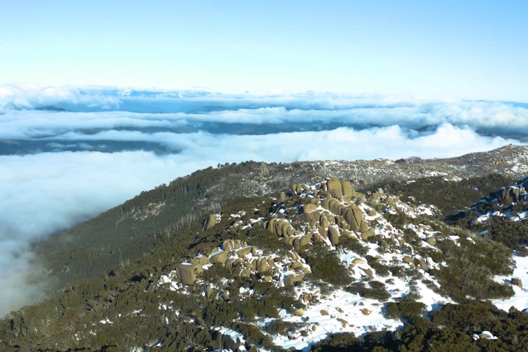 Aerial view of snow-capped mountains and low cloud
