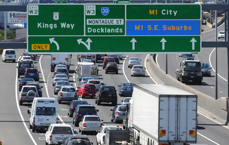 Motorists on a freeway in Melbourne with signs for the CityLink toll road.