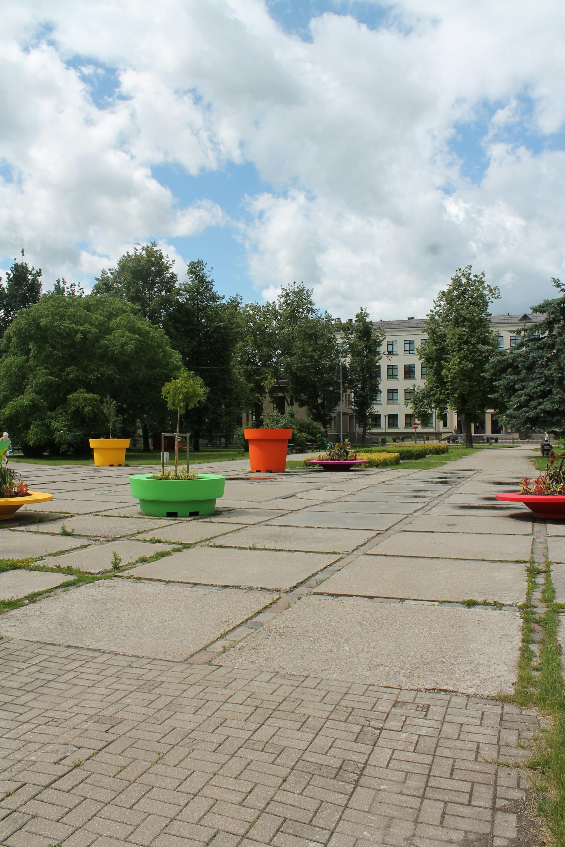 A public square in Latvia covered with colourful planters.