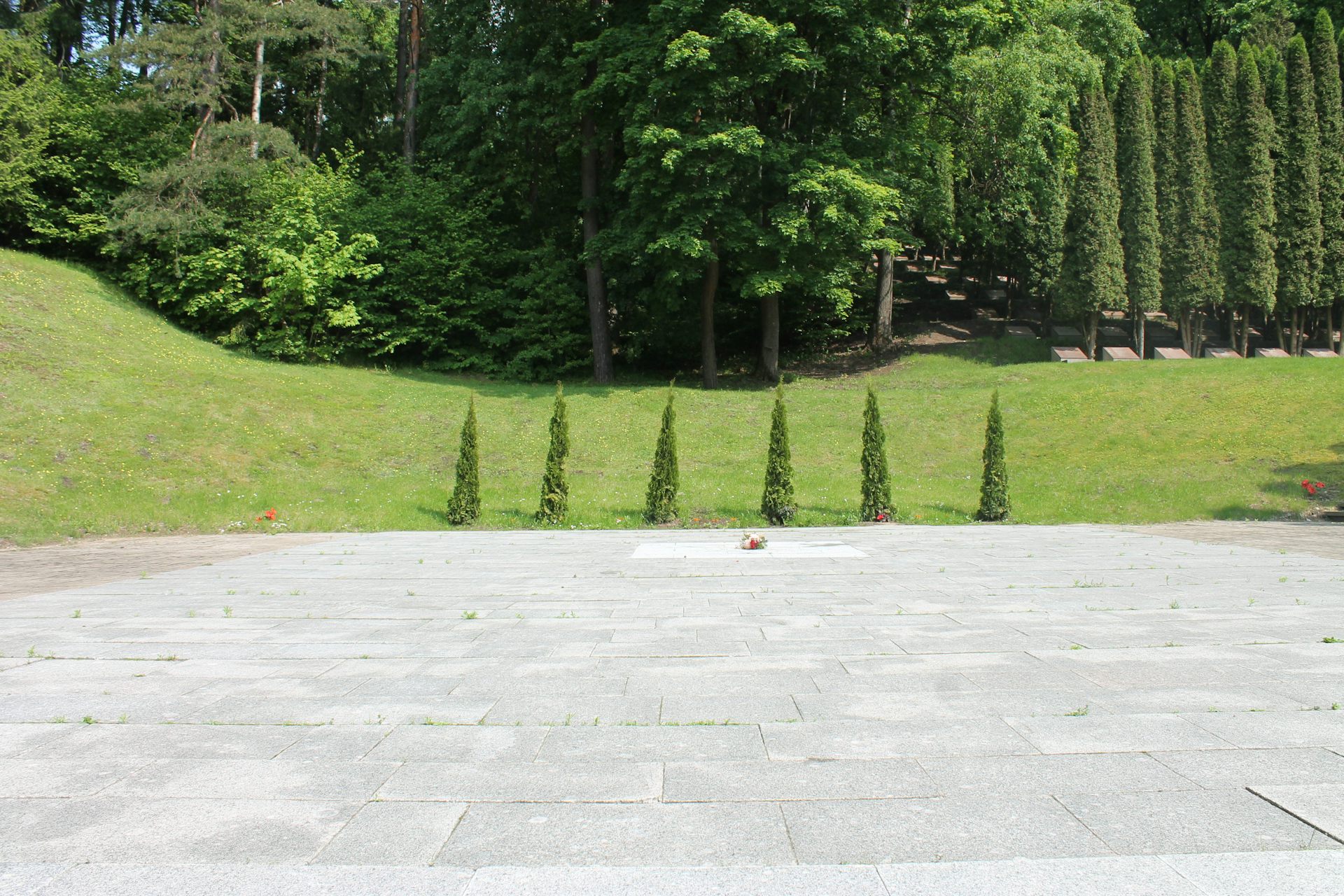 An empty memorial site where six granite statues once stood.