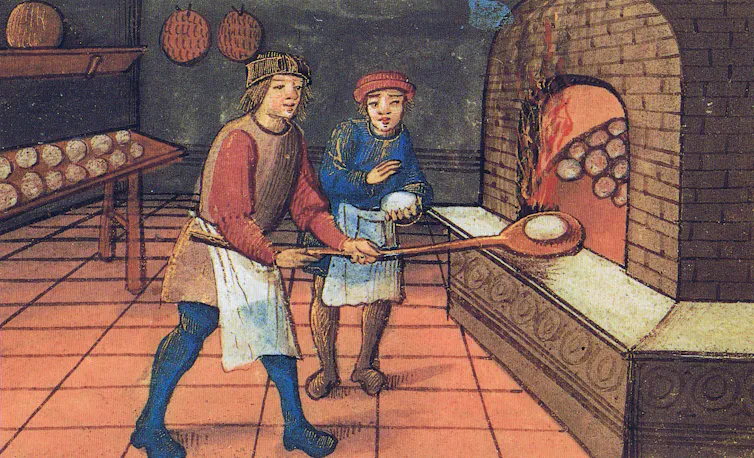 Medieval image of a baker putting bread into an oven