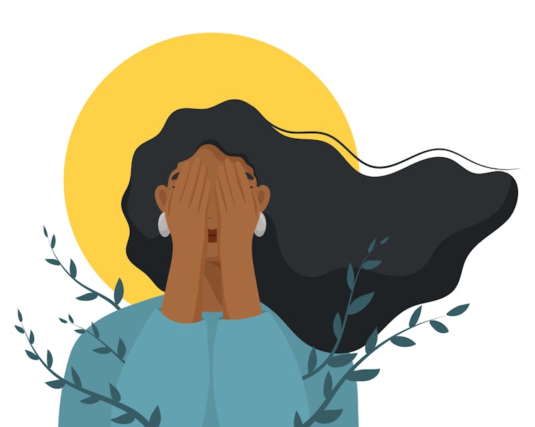 Image of a woman covering her face.