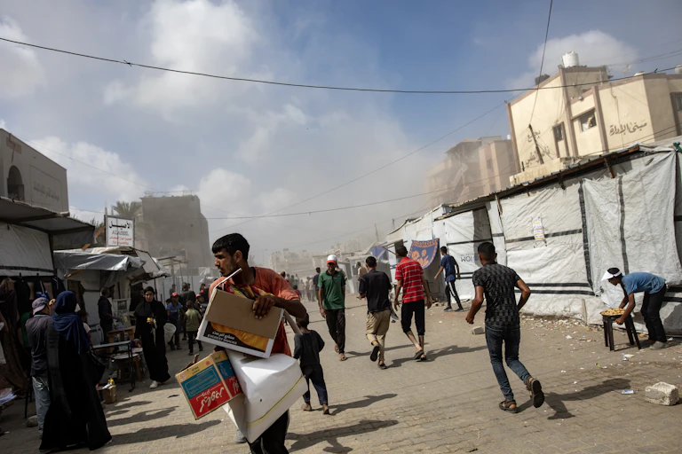 Palestinians flee following an Israeli airstrike on Nasser hospital.