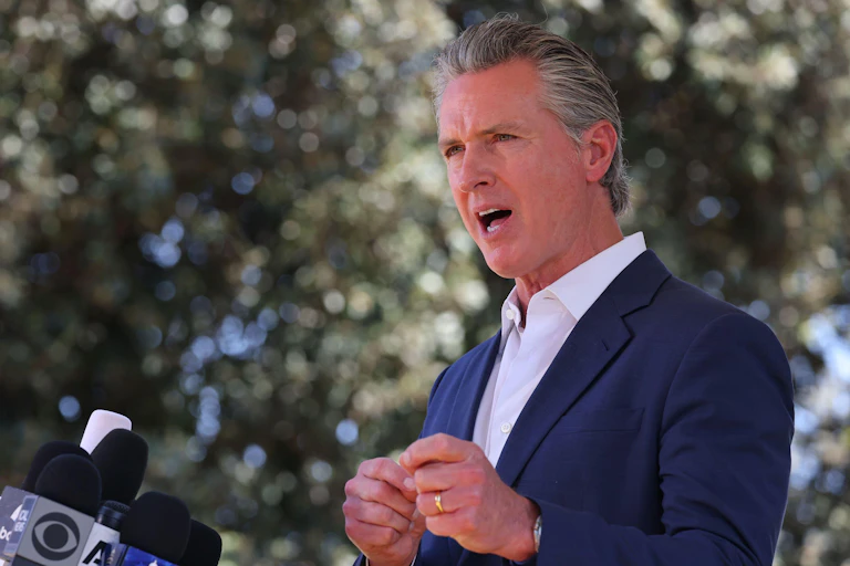 Headshot of Gavin Newsom at a press conference.