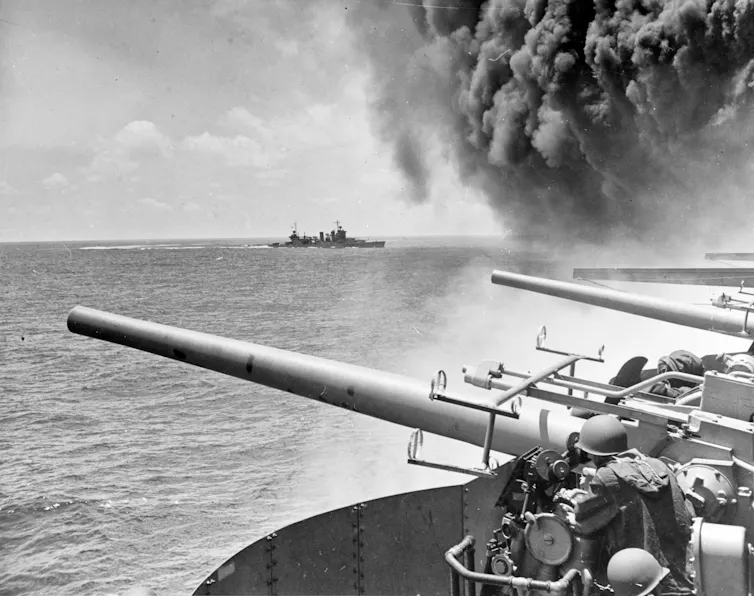 Archival image of an aircraft carrier billowing smoke.
