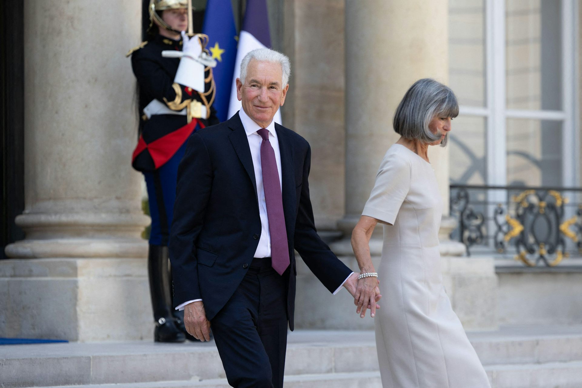 Charles Kushner, the new US ambassador to France, and his wife Seryl walk down steps at the Elysee Palace in Paris.