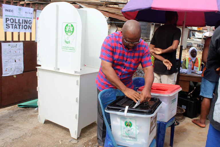 A man places a piece of paper in a plastic container