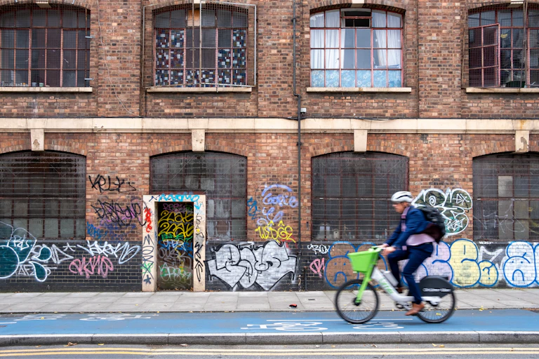 A man riding a bike on a cycle lane.