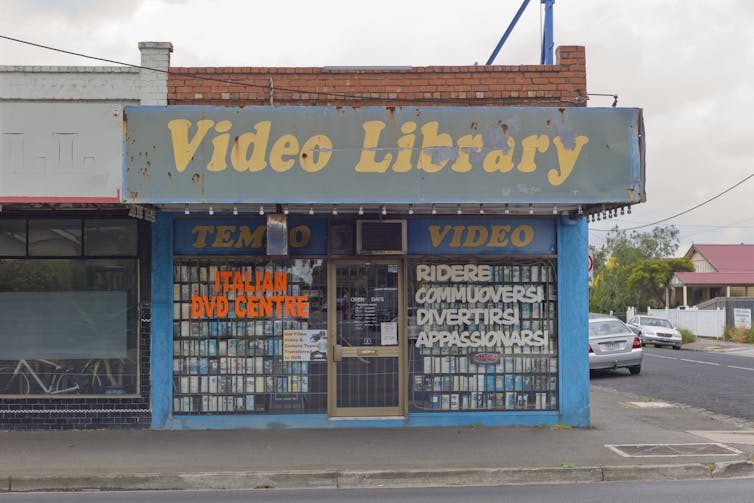 A suburban shopfront with Italian language writing on the front windows.