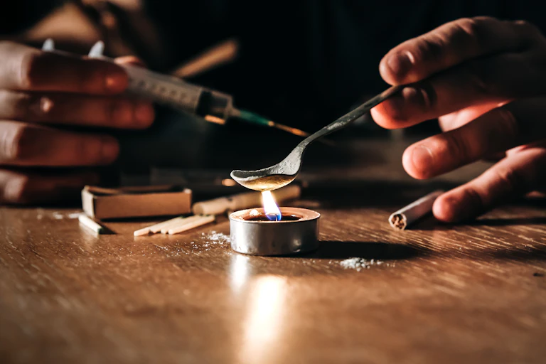 Person preparing a heroin fix.