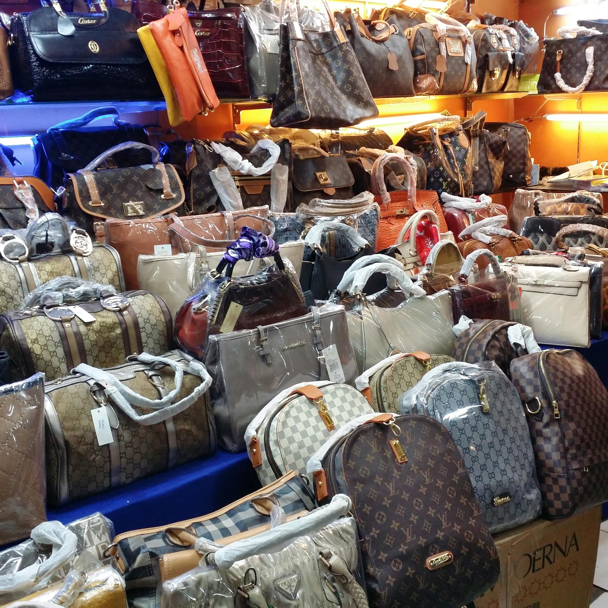 A display of counterfeit bags bearing the logos of the biggest names in luxury goods.