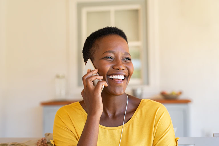Smiling woman talking on the phone.