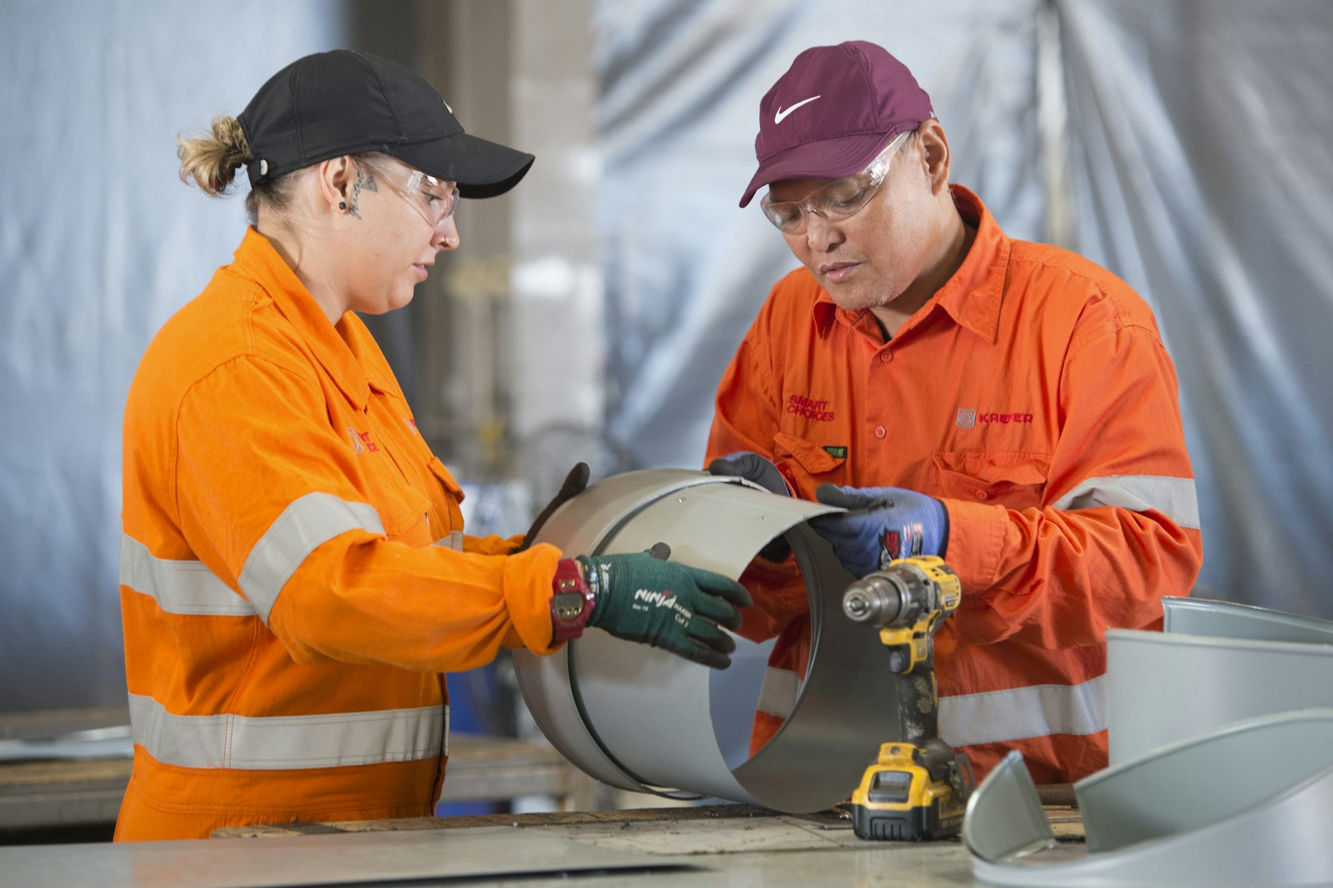 two workers inspecting a pipe