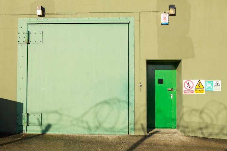 Two green armour-plated doors.