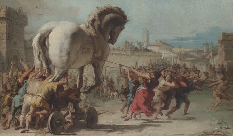 A painting of soldiers pulling a huge, white wooden horse.