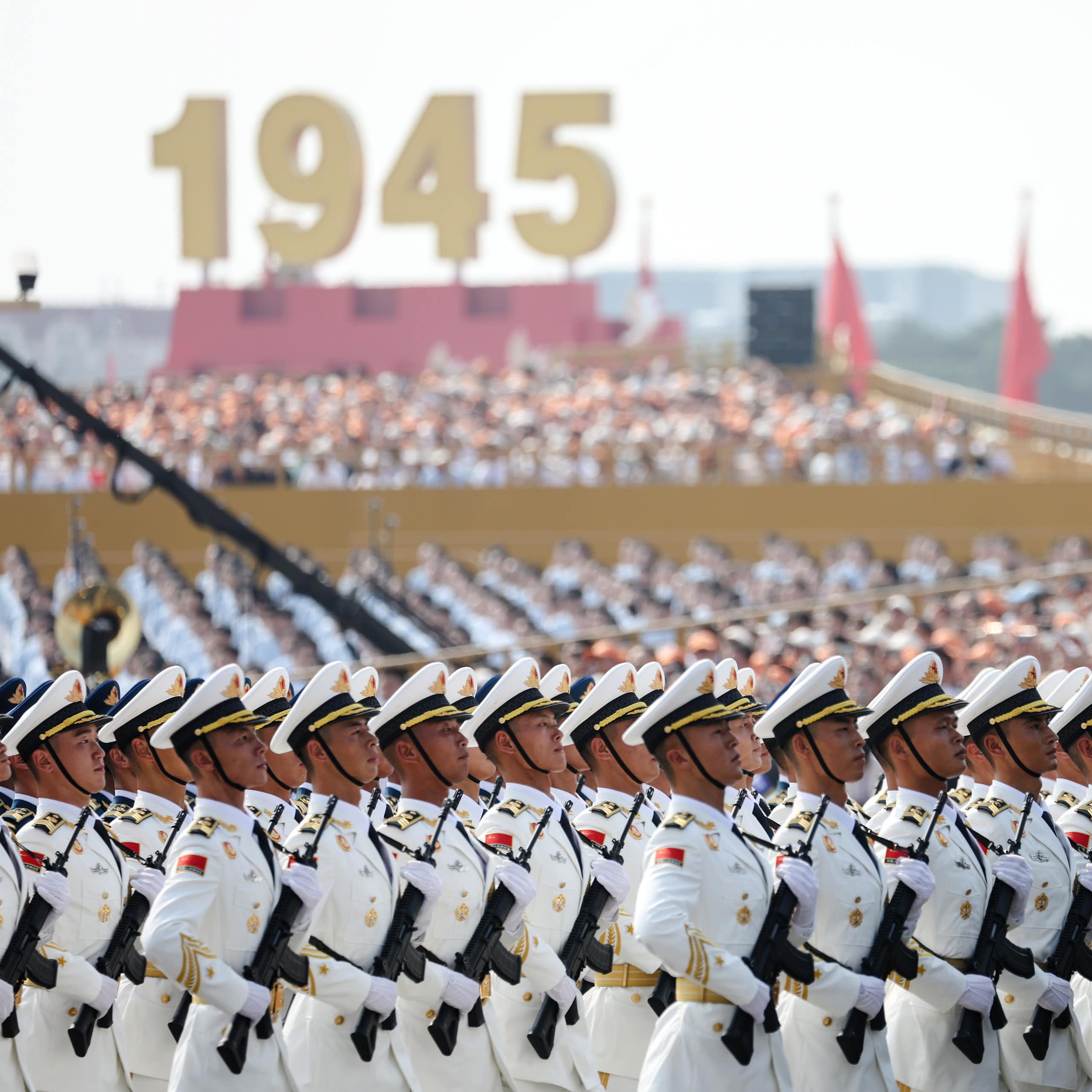 Image 23: Chinese military parade in front of large sign saying 1945.