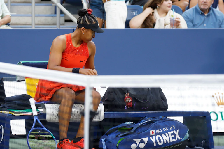 Naomi Osaka at the US Open with a Labubu doll.