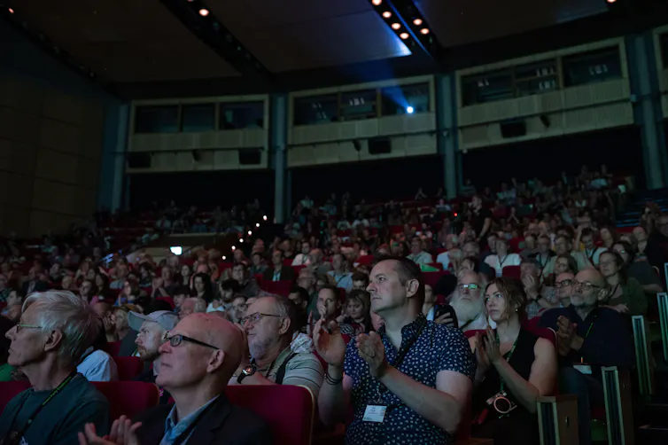 The audience in a conference hall.