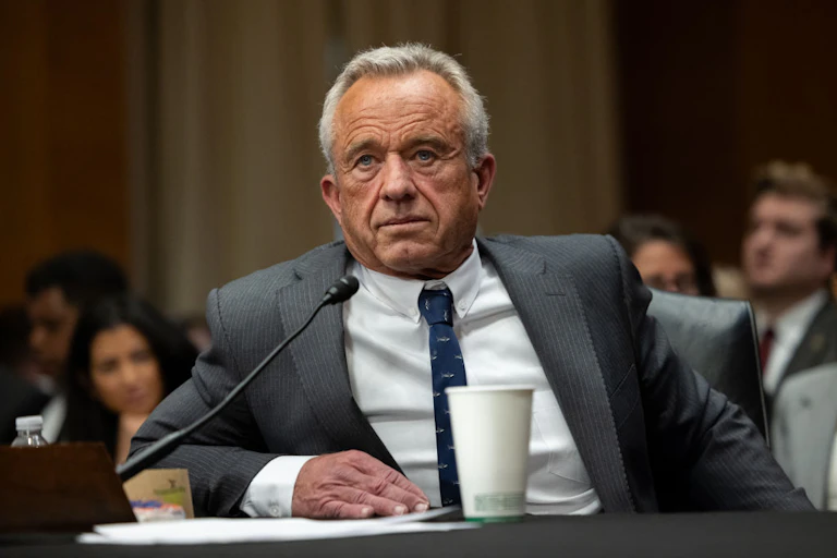 Robert F. Kennedy Jr. sits at a microphone in a hearing room