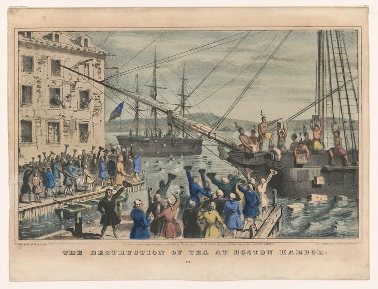 An illustration of colonists boarding ships in a harbour and dumping chests of tea into the water