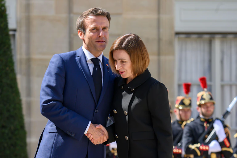 Moldova 's president shakes hands with France's Emmanuel Macron on a visit to Paris in 2022.