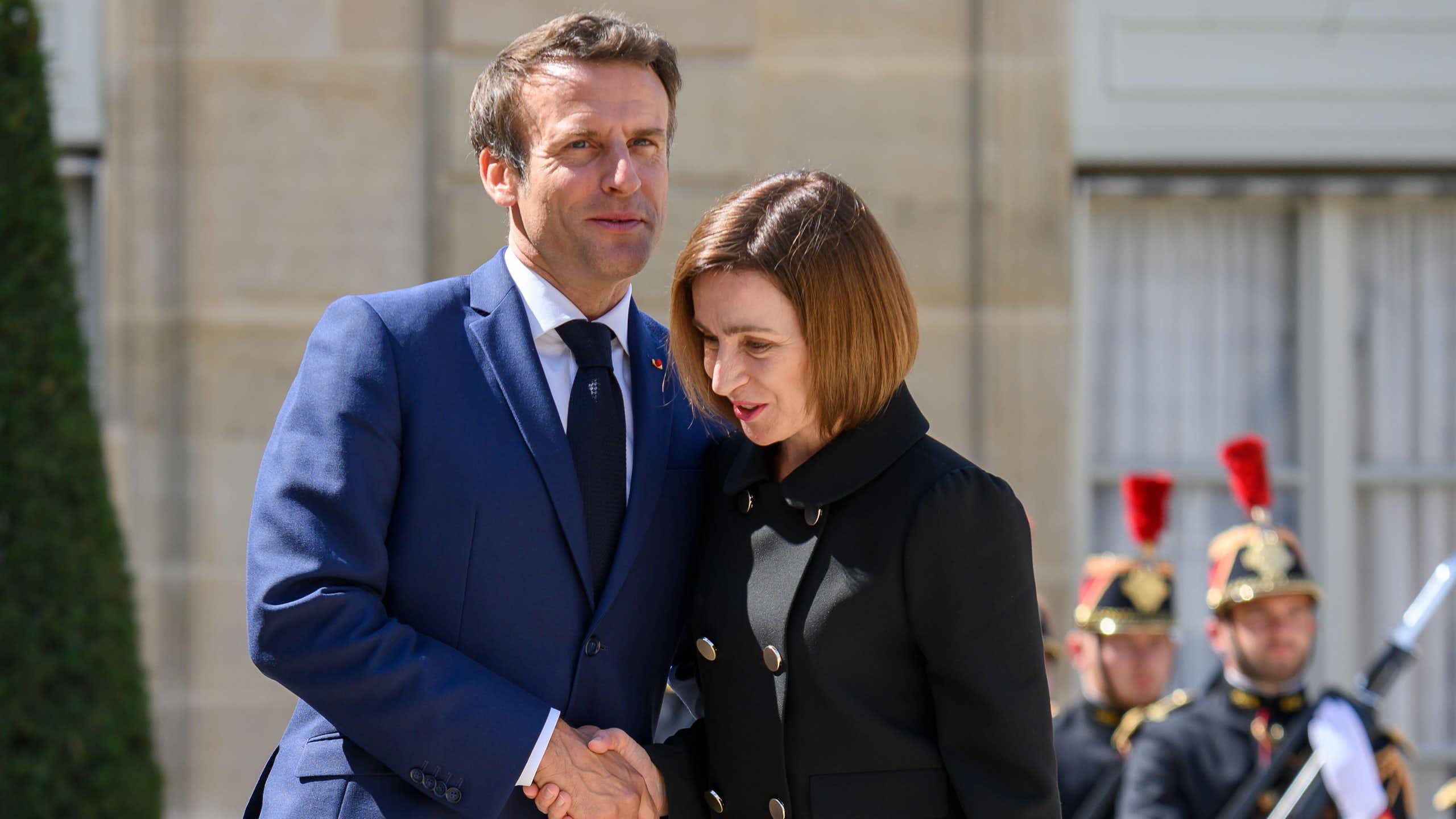 Moldova 's president shakes hands with France's Emmanuel Macron on a visit to Paris in 2022.