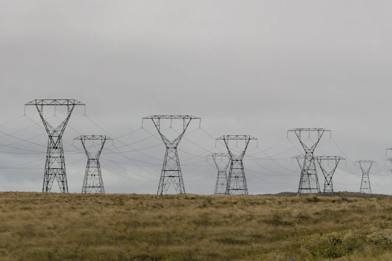 Rural landscape dotted with power pylons