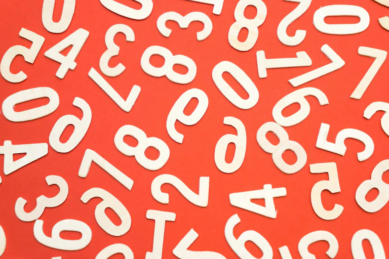 Scattered numbers, some the wrong way around, on a red background.
