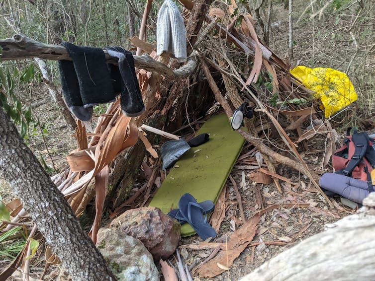 A bush hut made of tree branches.