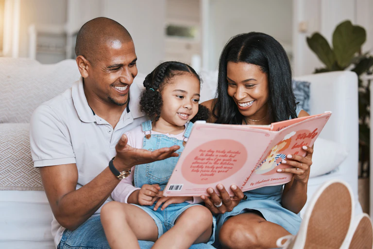 Parents and child reading book