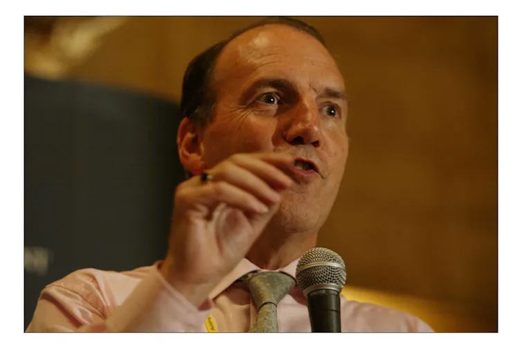 Close up of Simon Hughes behind a microphone.