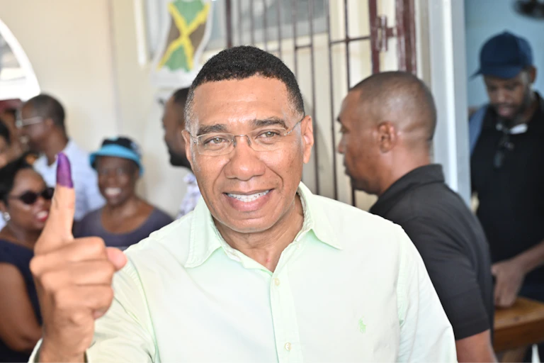 Andrew Holness poses after voting during the elections in Jamaica.