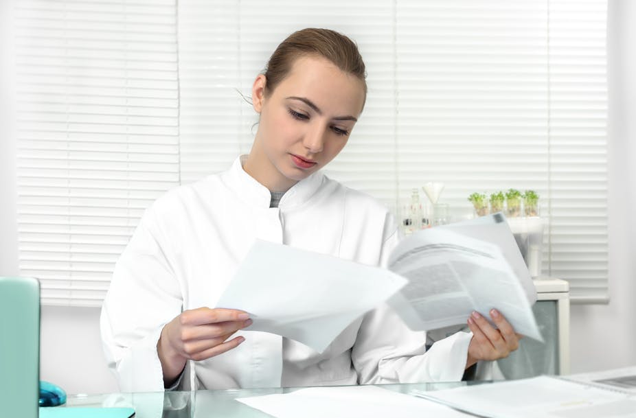 Young scientist reading an academic paper