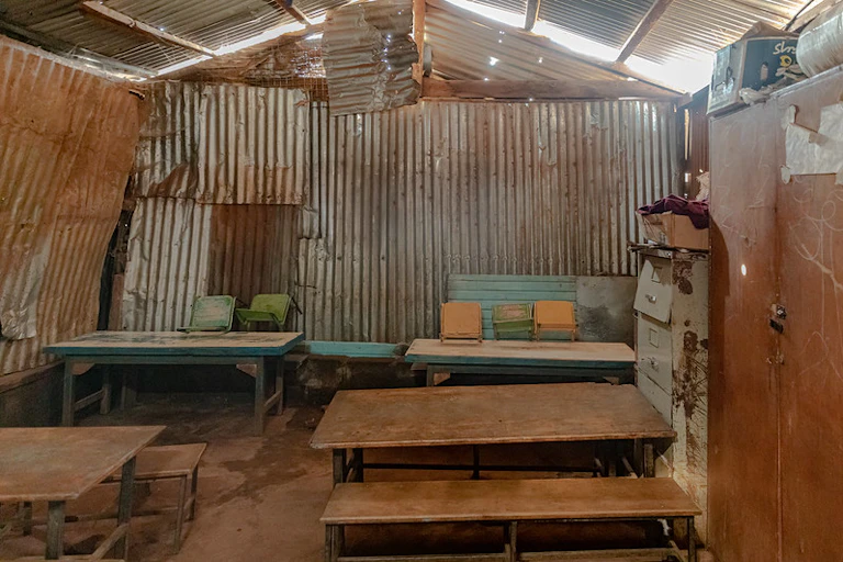 Desks and benches in a corrugated iron building