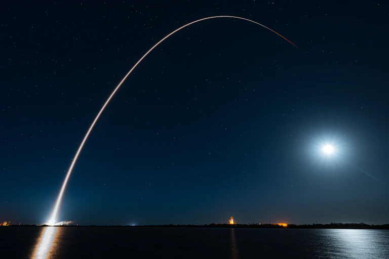 A satellite launch at night.
