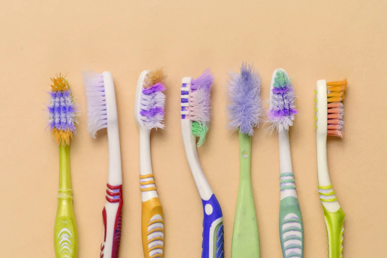 A row of used toothbrushes.