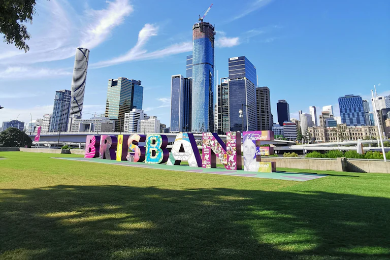 The Brisbane skyline is shown.