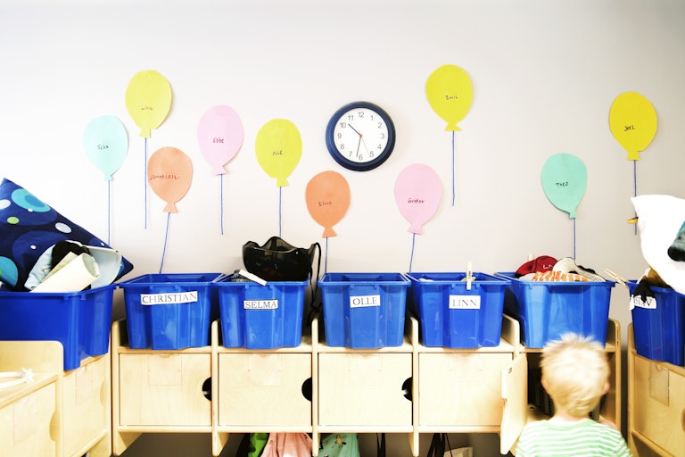 Tubs and cubby holes for children at a daycare.