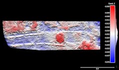 Blue and red image of parallel lines and a circular mark