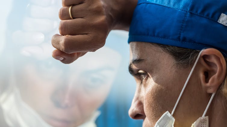 A medical worker looks dejected.
