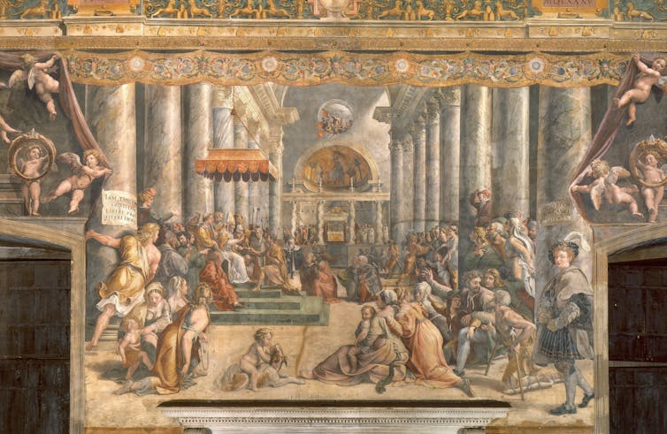 a large renaissance fresco with many characters in a large room. On the left a seated man in papal cassock is handed a gold figurine by a kneeling man.