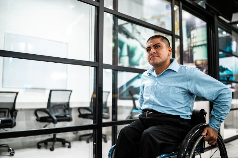 A man in a wheelchair in an office.