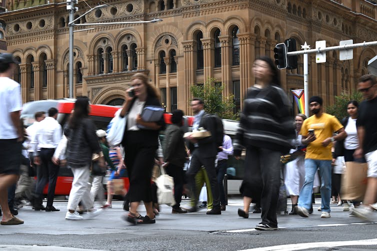 Sydney CBD workers walking across the road during lunchtime