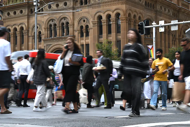 Sydney CBD workers walking across the road during lunchtime