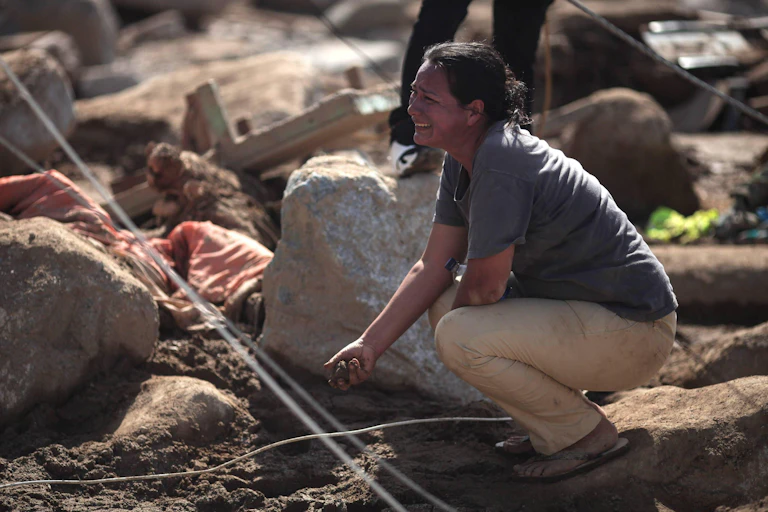 A woman surrounded by rubble mourns in Mocoa, Colombia, following a landslide.
