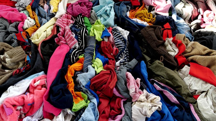 a large pile of used clothing for recycling