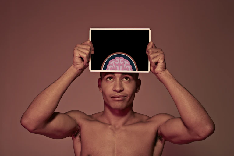 man holding tablet computer over image of his brain