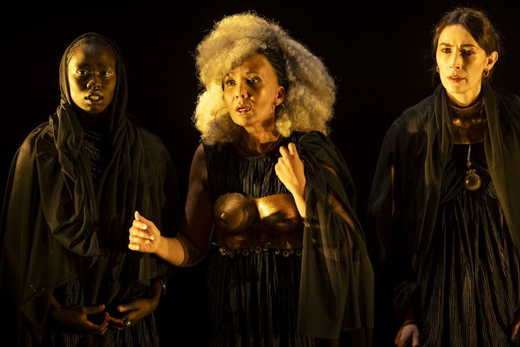 Three women on stage.